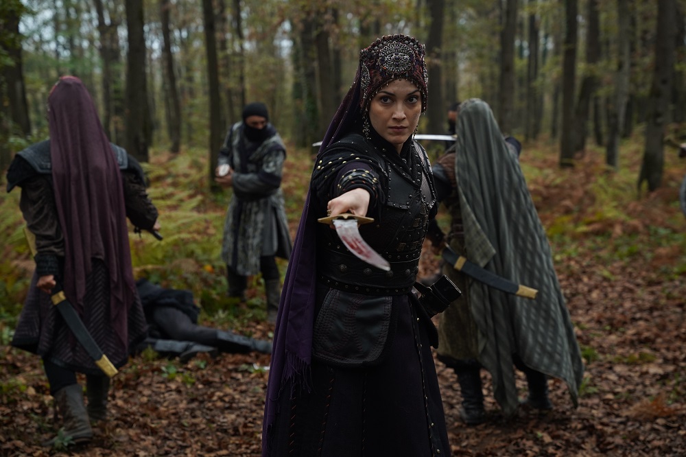 İnegöl’den getirdiği mühimmatla obaya dönmekte olan Fatma Hatun’un başında bulunduğu kervan, yolda düşman pususuna uğradı.
Saldırıyı fark eden Fatma Hatun, savaş düzeni alın talimatını vererek alpları ve bacıyanları savunma hattına çekti.
